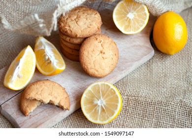 homemade lemon gingerbread cookies lie on a wooden board on a rustic table, still life of fresh biscuits with citrus, copy space - Powered by Shutterstock