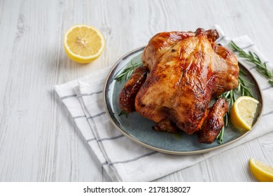 Homemade Lemon and Herb Rotisserie Chicken on a Plate, low angle view. Copy space. - Shutterstock ID 2178138027