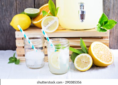 Homemade Lemonade In Beverage Dispenser And Mason Jars