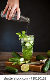 Homemade Lemonade Cucumber, Basil And Lime. Selective Focus.Female Hand Pouring Cream Soda