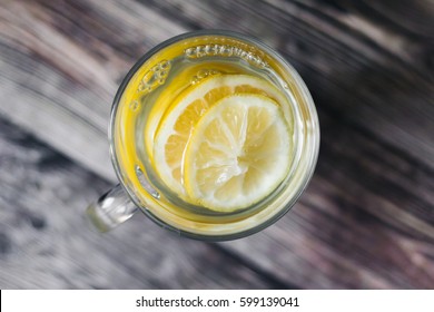 homemade lemonade with lemon  on a rustic wooden background.  top view.