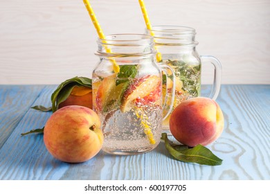 Homemade lemonade of ripe peaches and cold fresh mint. A jar of peach tea. Refreshing water.
