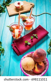 Homemade lemonade with ripe peaches and fresh mint.