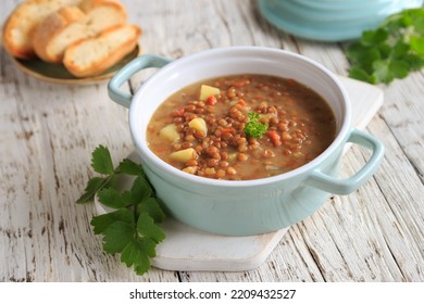 homemade lentil soup in a small soup pot - Shutterstock ID 2209432527