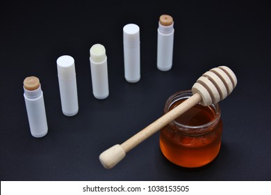 Homemade lip balm with honey, isolated on black background