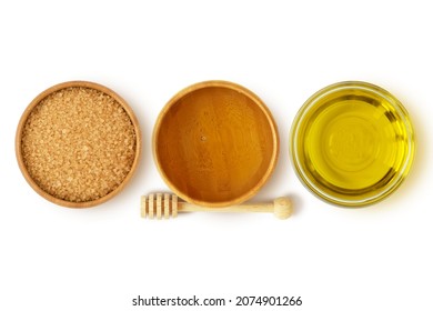 Homemade lip scrub made out of brown sugar, honey and olive oil on white background - Natural beauty recipe