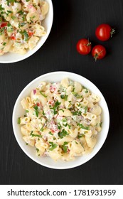 Homemade Macaroni Salad In A White Bowl On A Black Background, Top View. Flat Lay, Overhead, From Above.