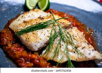 Home-made Mahi Mahi Fish Filet Served With Rosemary Lemon Slices On A Tomato Sauce, Meal Cooked At Home