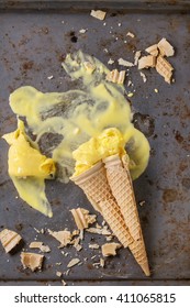 Homemade Mango Ice Cream In Broken Waffle Cone With Wafer Crumb Over Rusty Metal Textured Background. Top View