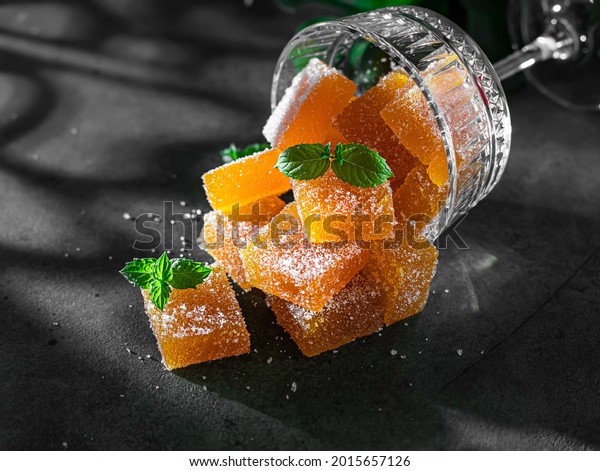 Homemade from\
mango and passionfruit jelly candies in sugar with mint. Homemade\
marmalade candy. Selective\
focus