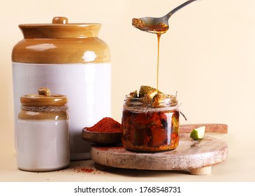 Homemade Mango Pickle or aam ka achar or Kairi Loncha in a white jar, selective focus  