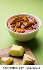 Homemade Mango Pickle or aam ka achar or Kairi Loncha in a white bowl, selective focus