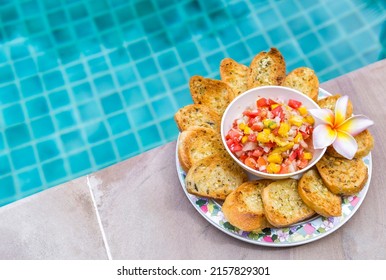 Homemade Mango Salsa With Garlic Bread With Space On Swimming Pool Edge Background, Healthy Snack