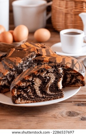 Homemade marble cake with a cup of coffee on wooden rustic table
