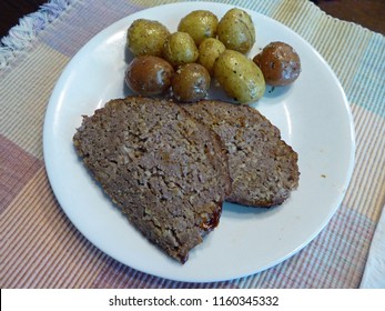 Homemade Meatloaf With Small Whole Potatoes Dressed In Garlic And Sea Salt