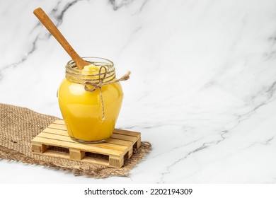 Homemade Melted ghee clarified butter. Bio Ayurveda Lactose free high quality butter on a light background. place for text, top view. - Shutterstock ID 2202194309