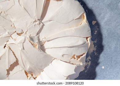 Homemade meringue. Large meringue on baking paper. Baking at home. Pavlova cake. Birthday cake.