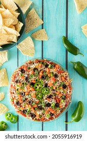 Homemade Mexican 7 Layer Dip Ready For Serving With Tortilla Chips.