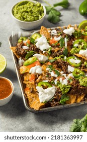 Homemade Mexican Shredded Beef Nachos With Gaucamole And Sour Cream