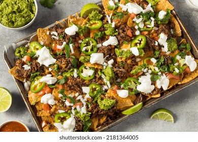 Homemade Mexican Shredded Beef Nachos With Gaucamole And Sour Cream