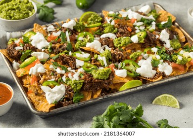 Homemade Mexican Shredded Beef Nachos With Gaucamole And Sour Cream