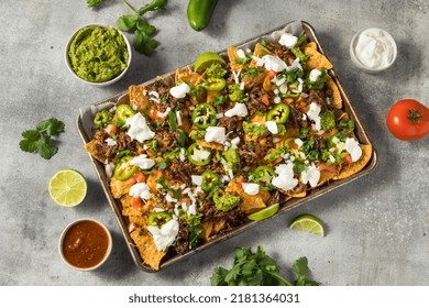 Homemade Mexican Shredded Beef Nachos With Gaucamole And Sour Cream