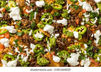 Homemade Mexican Shredded Beef Nachos With Gaucamole And Sour Cream