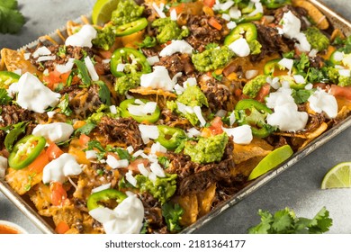 Homemade Mexican Shredded Beef Nachos With Gaucamole And Sour Cream