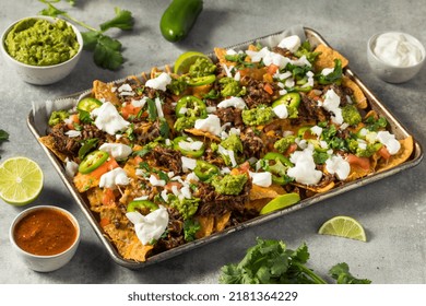 Homemade Mexican Shredded Beef Nachos With Gaucamole And Sour Cream