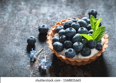 Homemade mini tart with blueberries and whipped cream - Powered by Shutterstock