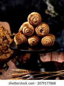 Homemade Mini Wholemeal Bread Stacked On A Black Cake Stand