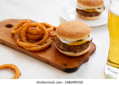 Homemade Mississippi Slug Burger With Onion Rings And Glass Of Cold Beer, Side View. Close-up.