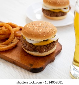 Homemade Mississippi Slug Burger With Onion Rings And Glass Of Cold Beer, Low Angle View. Close-up.