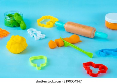 Homemade Modeling Clay Tools Kit On Blue Background. 