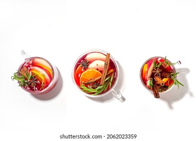 Homemade Mulled Wine Cocktail. Various Glass Mugs With Classic Winter Hot Spicy Mulled Wine, With Ingredients On White Background Flatlay Top View Copy Space