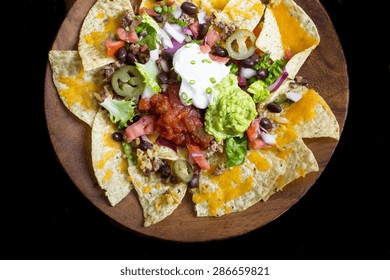 Homemade Nachos Isolated On Black, Overhead View