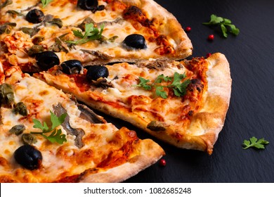 Homemade Napoli Pizza Or Anchovies Pizza On Black Slate Stone