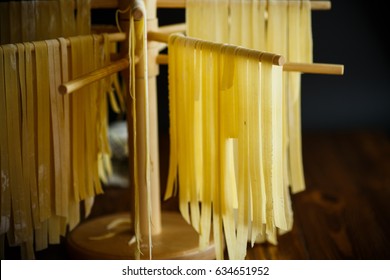 Home-made noodles are dried on a wooden stand - Powered by Shutterstock