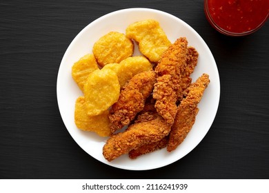 Homemade Nuggets And Chicken Tenders With Sweet And Sour Sauce On A Black Background, Top View. Flat Lay, Overhead, From Above.