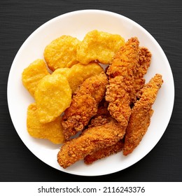 Homemade Nuggets And Chicken Tenders With Sweet And Sour Sauce On A Black Background, Top View. Overhead, From Above, Flat Lay. 