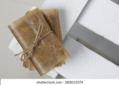 Homemade Nut & Dried Fruit Energy Bars. Wrapped in paper and tied with twine. On a white wooden box. - Powered by Shutterstock