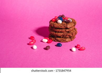 Homemade Oat Chocolate Cookies Stack With Cereal With Juicy Jelly Beans On Minimal Pink Purple Background, Angle View Copy Space