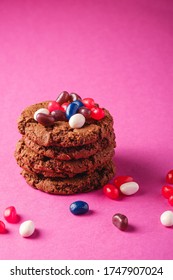 Homemade Oat Chocolate Cookies Stack With Cereal With Juicy Jelly Beans On Minimal Pink Purple Background, Angle View