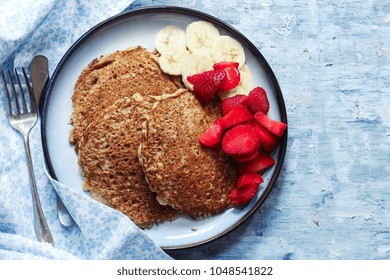 Homemade Oat Wheat Bran Pancakes Served With Fresh Strawberries And Banana / Healthy Breakfast Concept