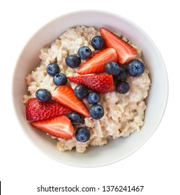 Homemade oatmeal with blueberries and strawberries in bowl isolated on white background. Healthy breakfast. Top view. - Shutterstock ID 1376241467