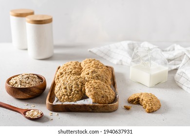 Homemade oatmeal cookies with banana, oats and nuts on a wooden tray and a cup of milk. Side view, copy space for text. Healthy food. Oatmeat biscuits. Horizontal - Powered by Shutterstock