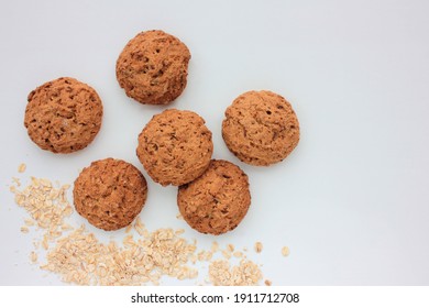 Homemade Oatmeal Cookies On White Table. Overhead View Of Oat Biscuits On White Background With Copy Space, Selective Focus