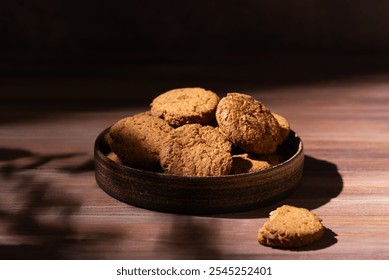 Homemade oatmeal cookies in a plate on a brown wooden table. - Powered by Shutterstock