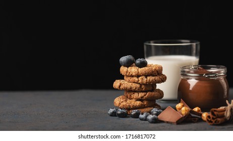 Homemade Oatmeal Cookies With A Stuffing Of Blueberry And Chocolate With Hazelnut, Chocolate Paste And Milk On Background. Still Life