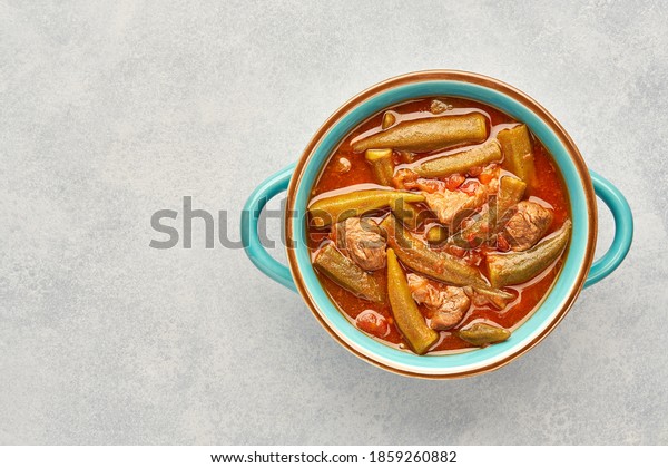 Homemade okra and meat stew in a pot. Top view,\
copy space